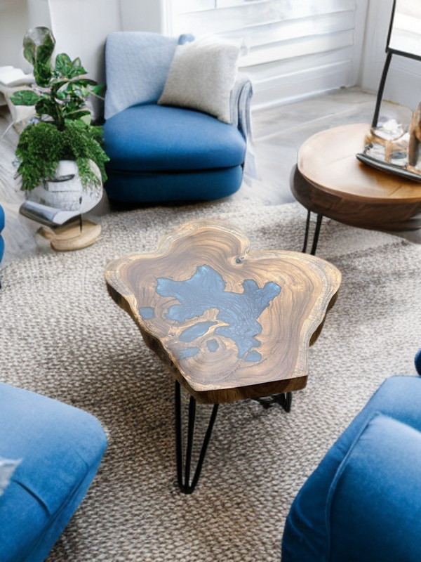 Live edge coffee table made from teak wood and blue epoxy resin, custom design in a modern Indian home setting.