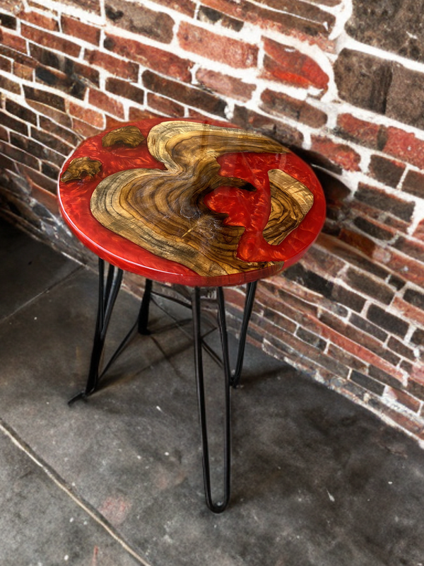 Handcrafted custom epoxy side table with natural wood and red resin top, supported by black metal hairpin legs.